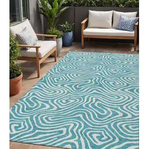Photo of Teal Blue And Ivory Abstract Washable Indoor Outdoor Area Rug