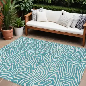 Photo of Teal Blue And Ivory Abstract Washable Indoor Outdoor Area Rug