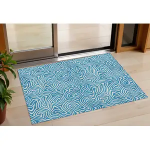 Photo of Teal Blue And Ivory Abstract Washable Indoor Outdoor Area Rug