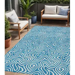 Photo of Teal Blue And Ivory Abstract Washable Indoor Outdoor Area Rug