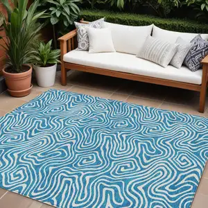 Photo of Teal Blue And Ivory Abstract Washable Indoor Outdoor Area Rug