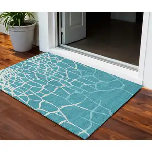 Photo of Teal Blue And Ivory Abstract Washable Indoor Outdoor Area Rug
