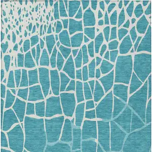 Photo of Teal Blue And Ivory Abstract Washable Indoor Outdoor Area Rug