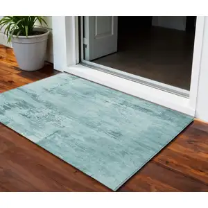 Photo of Teal Blue And Ivory Abstract Washable Indoor Outdoor Area Rug
