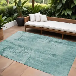 Photo of Teal Blue And Ivory Abstract Washable Indoor Outdoor Area Rug