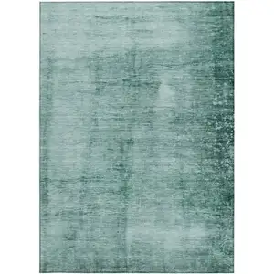 Photo of Teal Blue And Ivory Abstract Washable Indoor Outdoor Area Rug