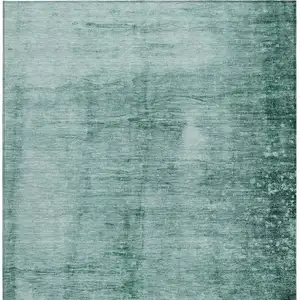 Photo of Teal Blue And Ivory Abstract Washable Indoor Outdoor Area Rug