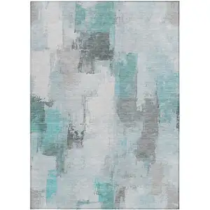 Photo of Teal Blue And Ivory Abstract Washable Indoor Outdoor Area Rug
