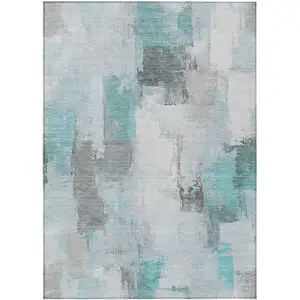 Photo of Teal Blue And Ivory Abstract Washable Indoor Outdoor Area Rug