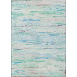 Photo of Teal Blue And Ivory Abstract Washable Indoor Outdoor Area Rug