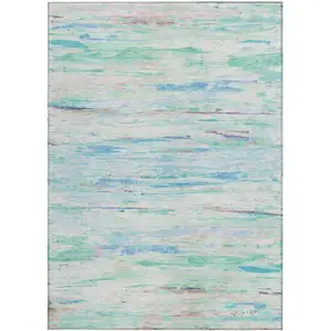 Photo of Teal Blue And Ivory Abstract Washable Indoor Outdoor Area Rug