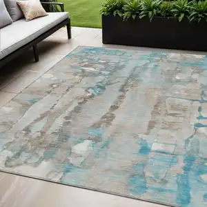 Photo of Teal Blue And Ivory Abstract Washable Indoor Outdoor Area Rug