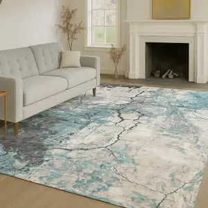 Photo of Teal Blue And Ivory Abstract Washable Indoor Outdoor Area Rug
