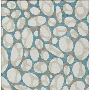 Photo of Teal Blue And Ivory Abstract Washable Indoor Outdoor Area Rug