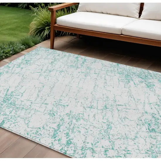 Teal Blue And Ivory Abstract Washable Indoor Outdoor Area Rug Photo 1
