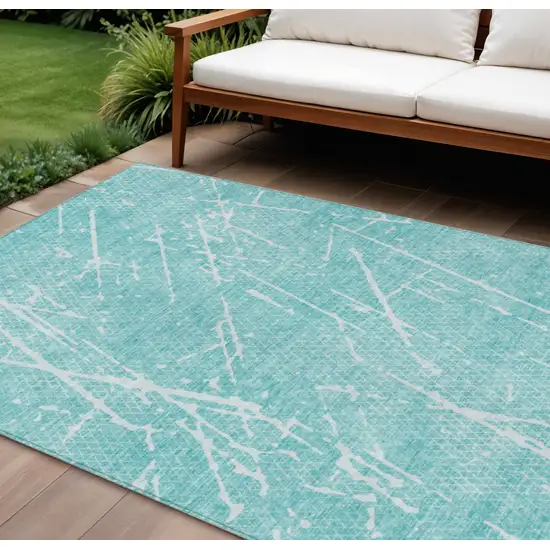 Teal Blue And Ivory Abstract Washable Indoor Outdoor Area Rug Photo 1