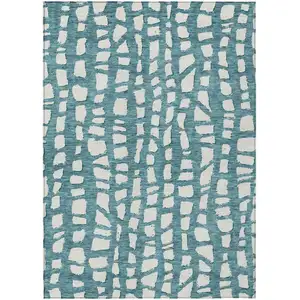 Photo of Teal Blue And Ivory Abstract Washable Indoor Outdoor Area Rug