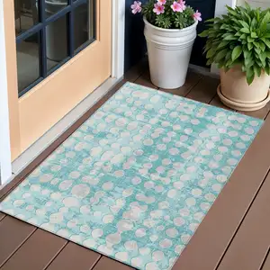 Photo of Teal Blue And Ivory Abstract Washable Indoor Outdoor Area Rug
