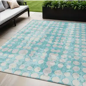 Photo of Teal Blue And Ivory Abstract Washable Indoor Outdoor Area Rug