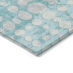 Photo of Teal Blue And Ivory Abstract Washable Indoor Outdoor Area Rug