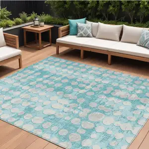 Photo of Teal Blue And Ivory Abstract Washable Indoor Outdoor Area Rug