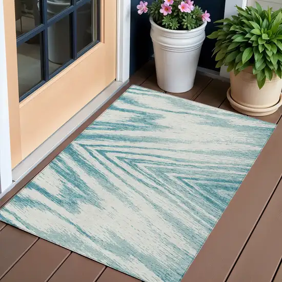 Teal Blue And Ivory Abstract Washable Indoor Outdoor Area Rug Photo 1