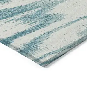 Photo of Teal Blue And Ivory Abstract Washable Indoor Outdoor Area Rug