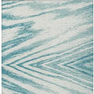 Photo of Teal Blue And Ivory Abstract Washable Indoor Outdoor Area Rug