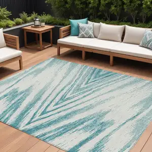 Photo of Teal Blue And Ivory Abstract Washable Indoor Outdoor Area Rug