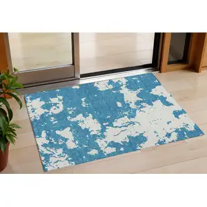 Photo of Teal Blue And Ivory Abstract Washable Indoor Outdoor Area Rug