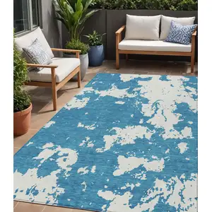 Photo of Teal Blue And Ivory Abstract Washable Indoor Outdoor Area Rug