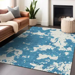 Photo of Teal Blue And Ivory Abstract Washable Indoor Outdoor Area Rug