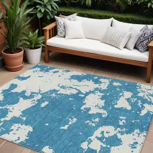 Photo of Teal Blue And Ivory Abstract Washable Indoor Outdoor Area Rug