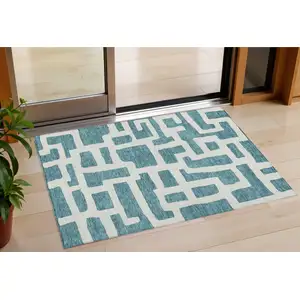 Photo of Teal Blue And Ivory Abstract Washable Indoor Outdoor Area Rug