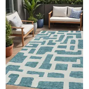 Photo of Teal Blue And Ivory Abstract Washable Indoor Outdoor Area Rug