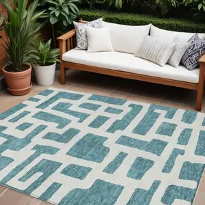 Photo of Teal Blue And Ivory Abstract Washable Indoor Outdoor Area Rug