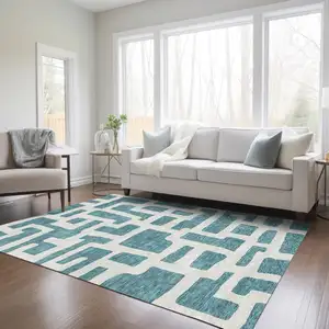 Photo of Teal Blue And Ivory Abstract Washable Indoor Outdoor Area Rug