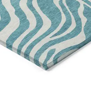 Photo of Teal Blue And Ivory Animal Print Washable Indoor Outdoor Area Rug