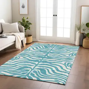 Photo of Teal Blue And Ivory Animal Print Washable Indoor Outdoor Area Rug
