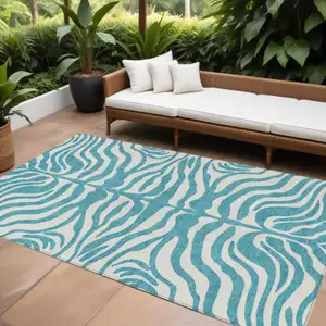 Photo of Teal Blue And Ivory Animal Print Washable Indoor Outdoor Area Rug