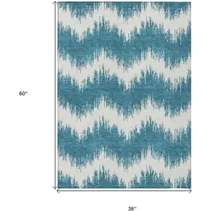 Photo of Teal Blue And Ivory Chevron Washable Indoor Outdoor Area Rug