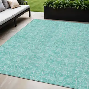 Photo of Teal Blue And Ivory Floral Washable Indoor Outdoor Area Rug