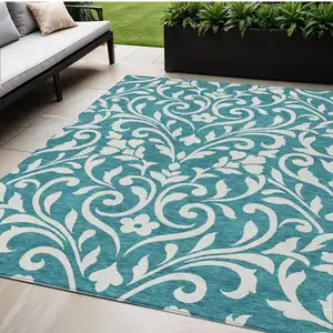 Photo of Teal Blue And Ivory Floral Washable Indoor Outdoor Area Rug