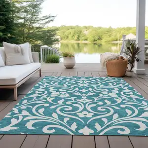 Photo of Teal Blue And Ivory Floral Washable Indoor Outdoor Area Rug
