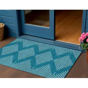 Photo of Teal Blue And Ivory Geometric Washable Indoor Outdoor Area Rug