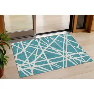 Photo of Teal Blue And Ivory Geometric Washable Indoor Outdoor Area Rug