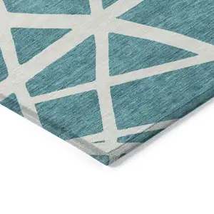 Photo of Teal Blue And Ivory Geometric Washable Indoor Outdoor Area Rug