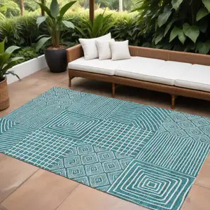 Photo of Teal Blue And Ivory Geometric Washable Indoor Outdoor Area Rug