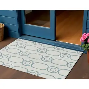 Photo of Teal Blue And Ivory Geometric Washable Indoor Outdoor Area Rug