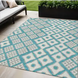 Photo of Teal Blue And Ivory Geometric Washable Indoor Outdoor Area Rug